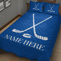 Blue hockey bedding displayed in a bedroom with crossed sticks, puck artwork, and bold sports styling