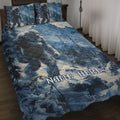 Blue Bigfoot quilt blanket displayed on a bed with matching forest and mountain artwork