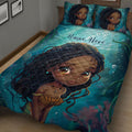Close view of Black African girl artwork on a teal quilt blanket spread across a bed