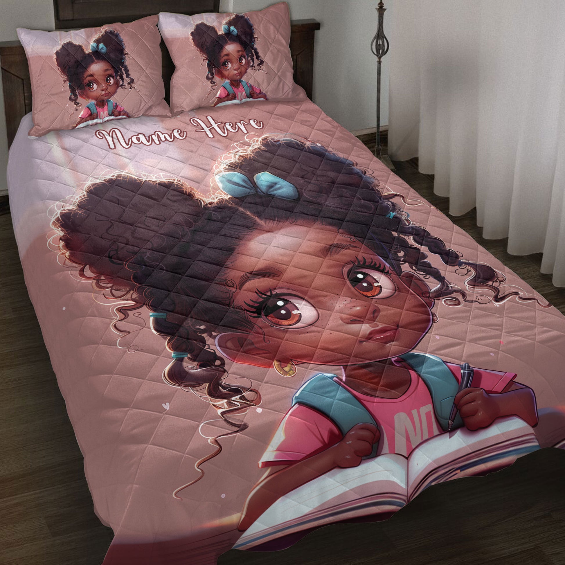 Pink quilt blanket on a bed featuring a large Black girl illustration with colorful clothing and matching pillow artwork