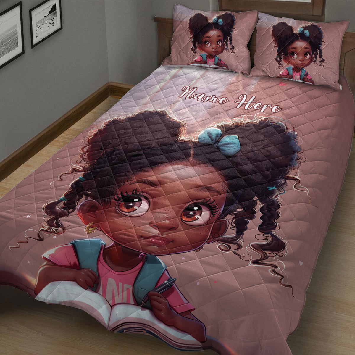 Close view of a pink quilt blanket featuring a joyful Black girl illustration with curly hair and blue bows