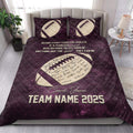 Purple football quilt blanket styled on a bedroom bed with inspirational coach artwork