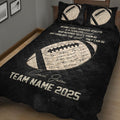 Black football quilt blanket displayed at an angle with football artwork and team-inspired design