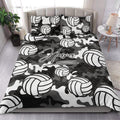 Black and white camouflage volleyball quilt blanket styled in a modern bedroom