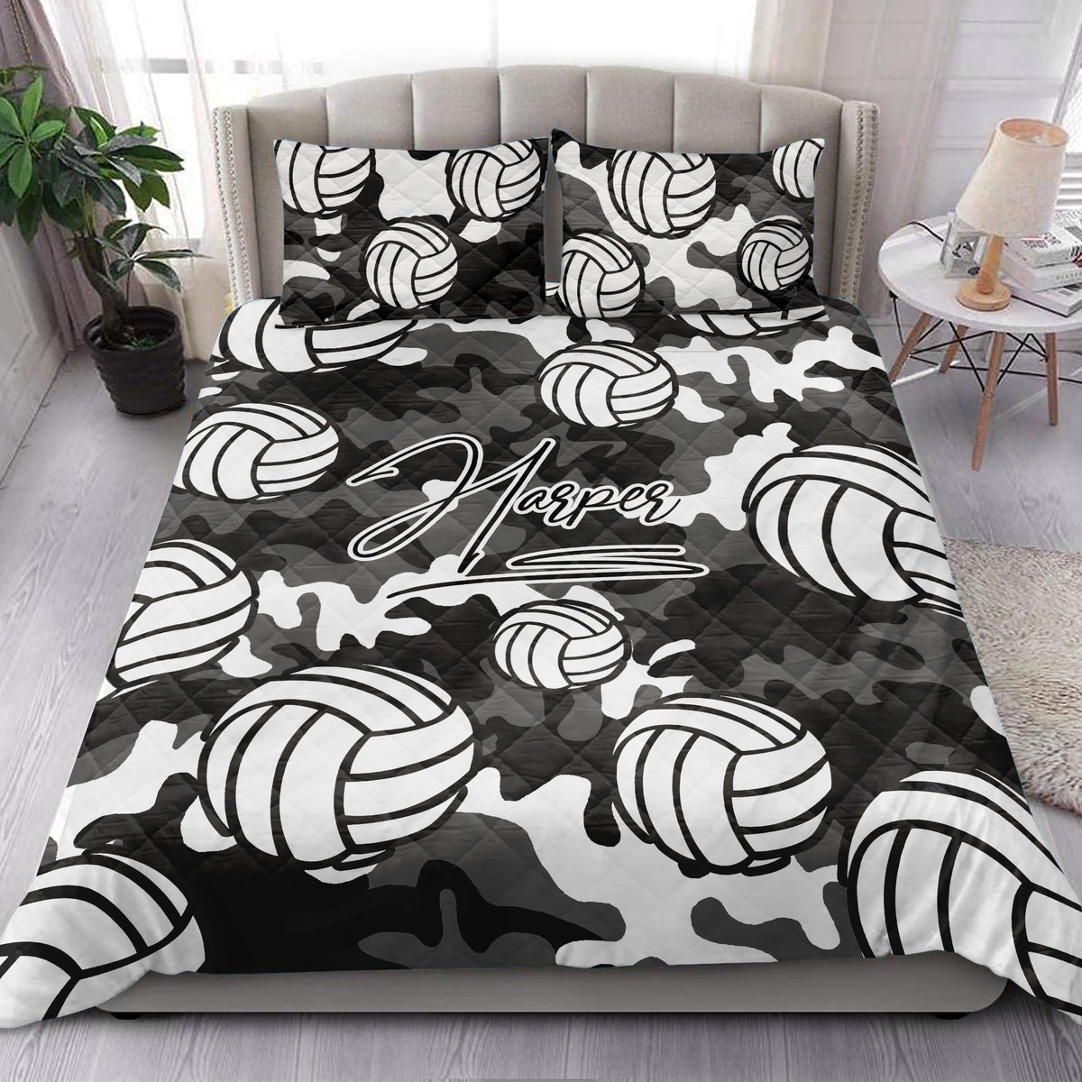 Black and white camouflage volleyball quilt blanket styled in a modern bedroom