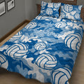 Blue volleyball quilt blanket displayed on a bed with bold sports artwork