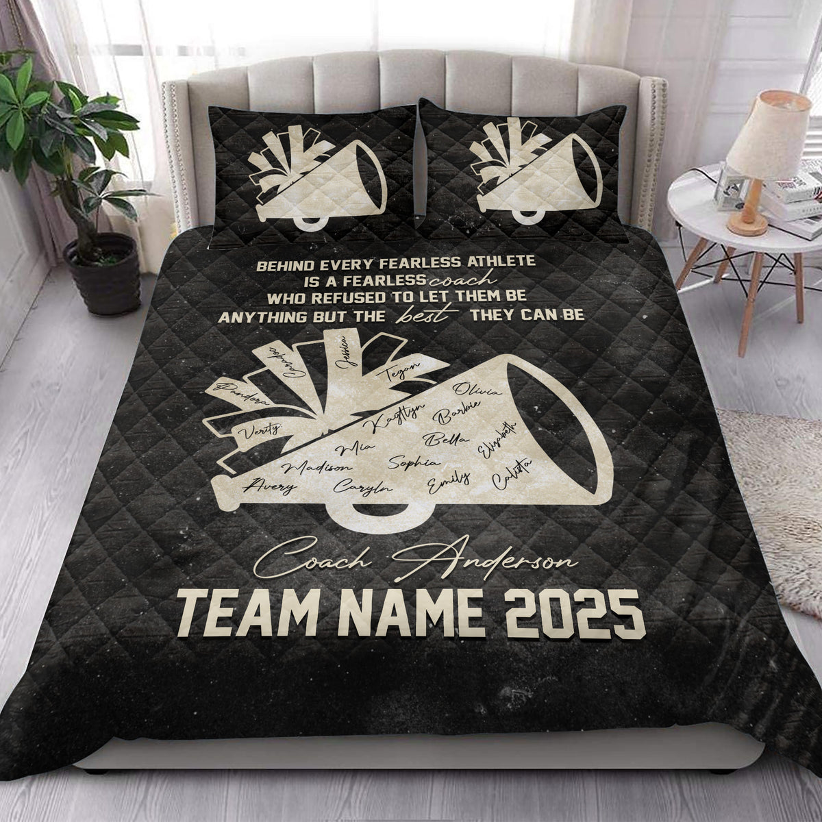 Black cheerleading quilt blanket styled on a bedroom bed with megaphone and team tribute artwork
