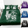 Cheerleading quilt blanket displayed on a bed with pom poms, megaphones, bows, and bold team-inspired artwork