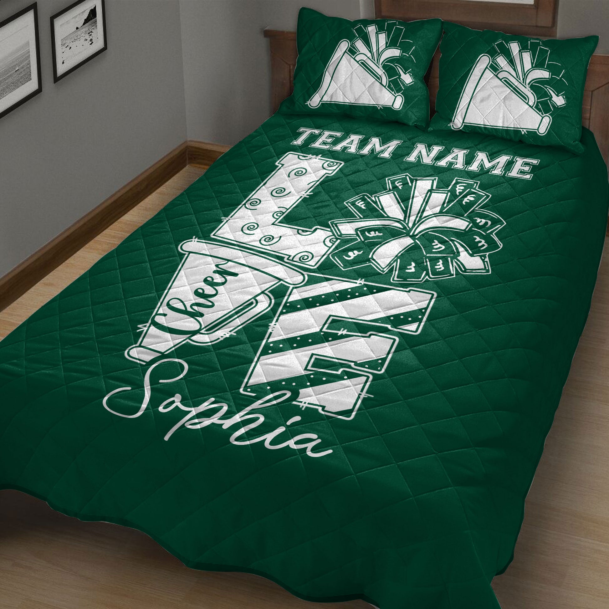 Green cheerleading quilt blanket on a bed with large pom pom and megaphone artwork
