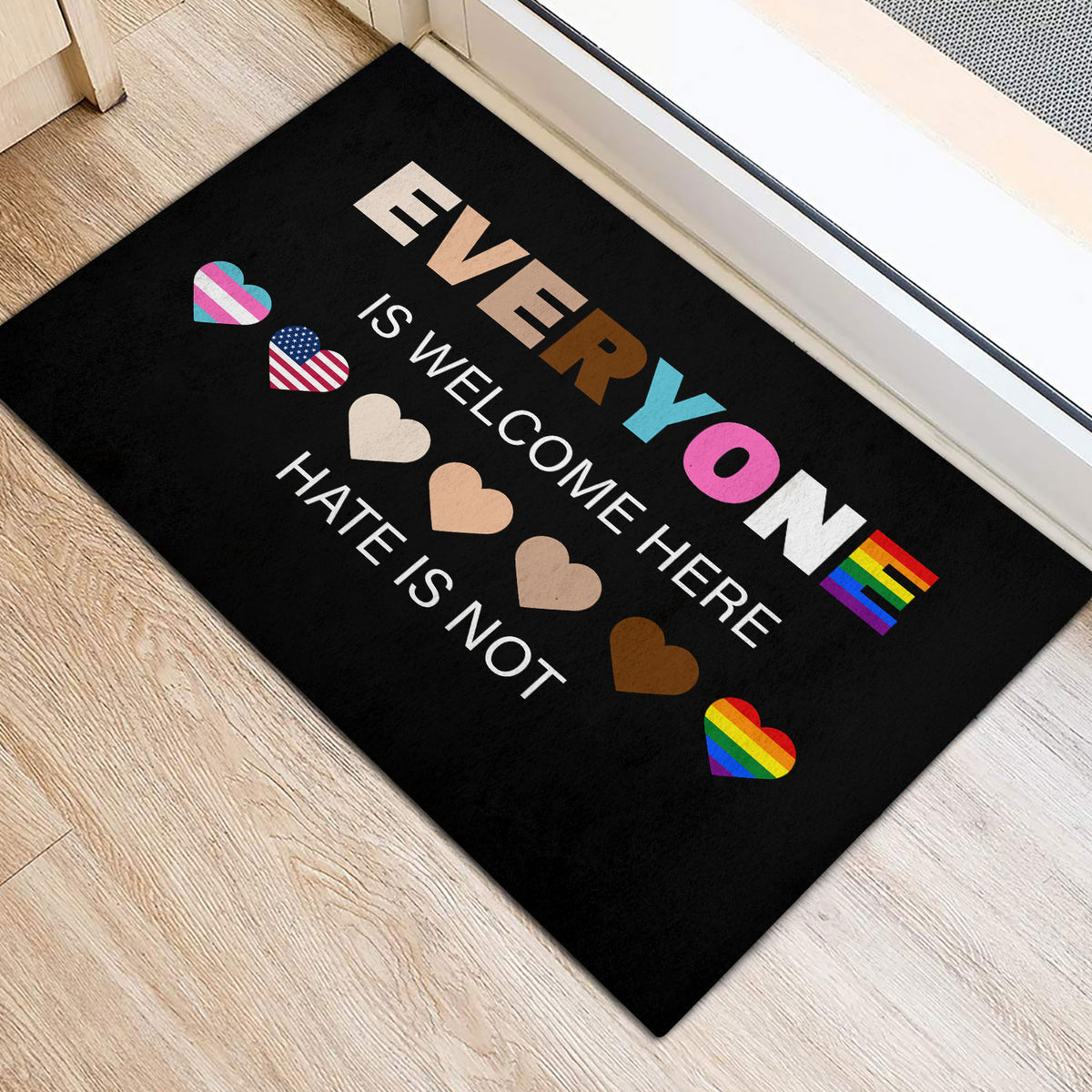 Black LGBT door mat with rainbow hearts and welcoming typography