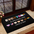 LGBT doormat styled at a home entrance with rainbow hearts and bold text