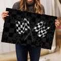 Racing doormat held indoors showing crossed black and white checkered flags