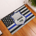 Police badge door mat displayed at a home entrance on a warm wood floor