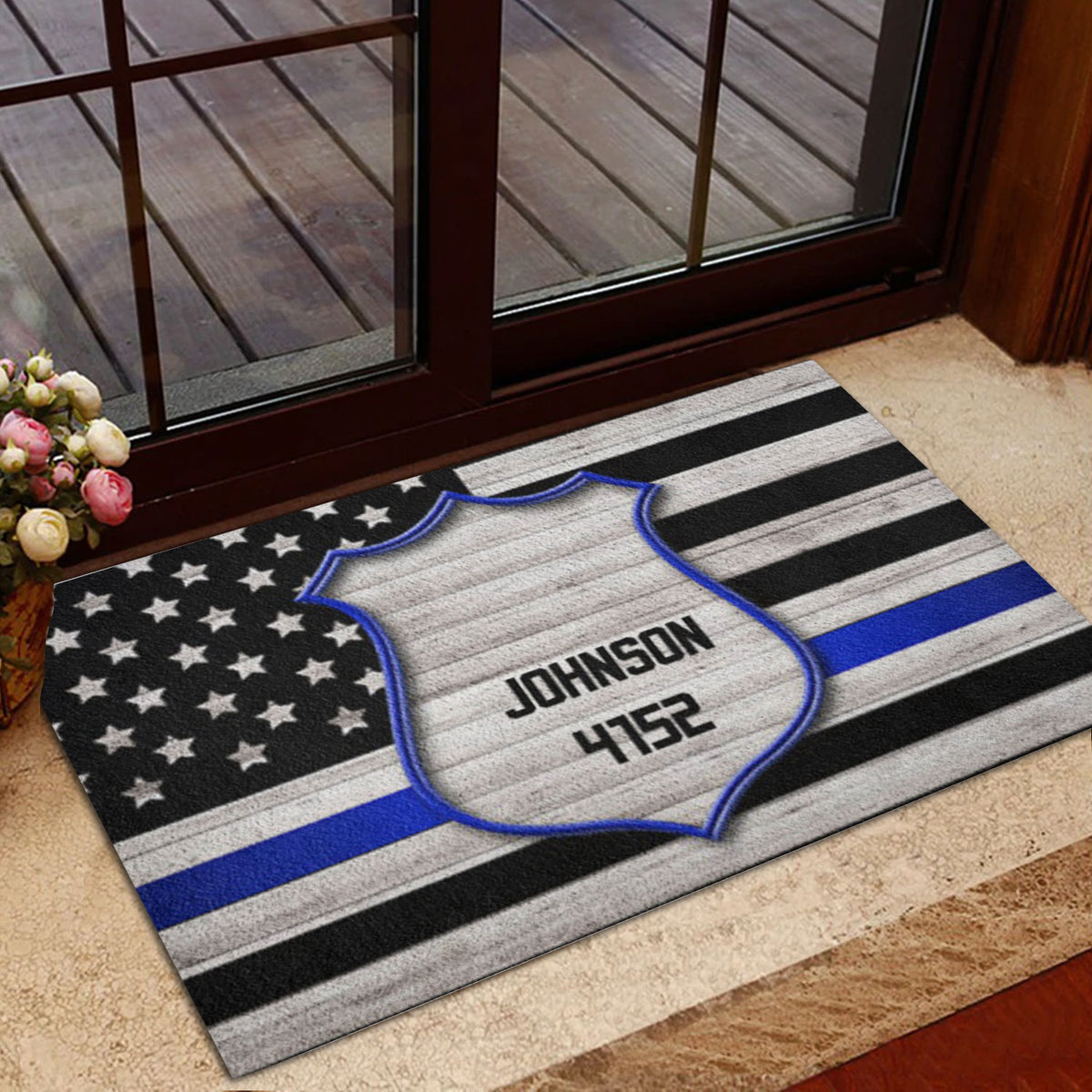 Police badge doormat placed at an interior doorway with a blue stripe flag design