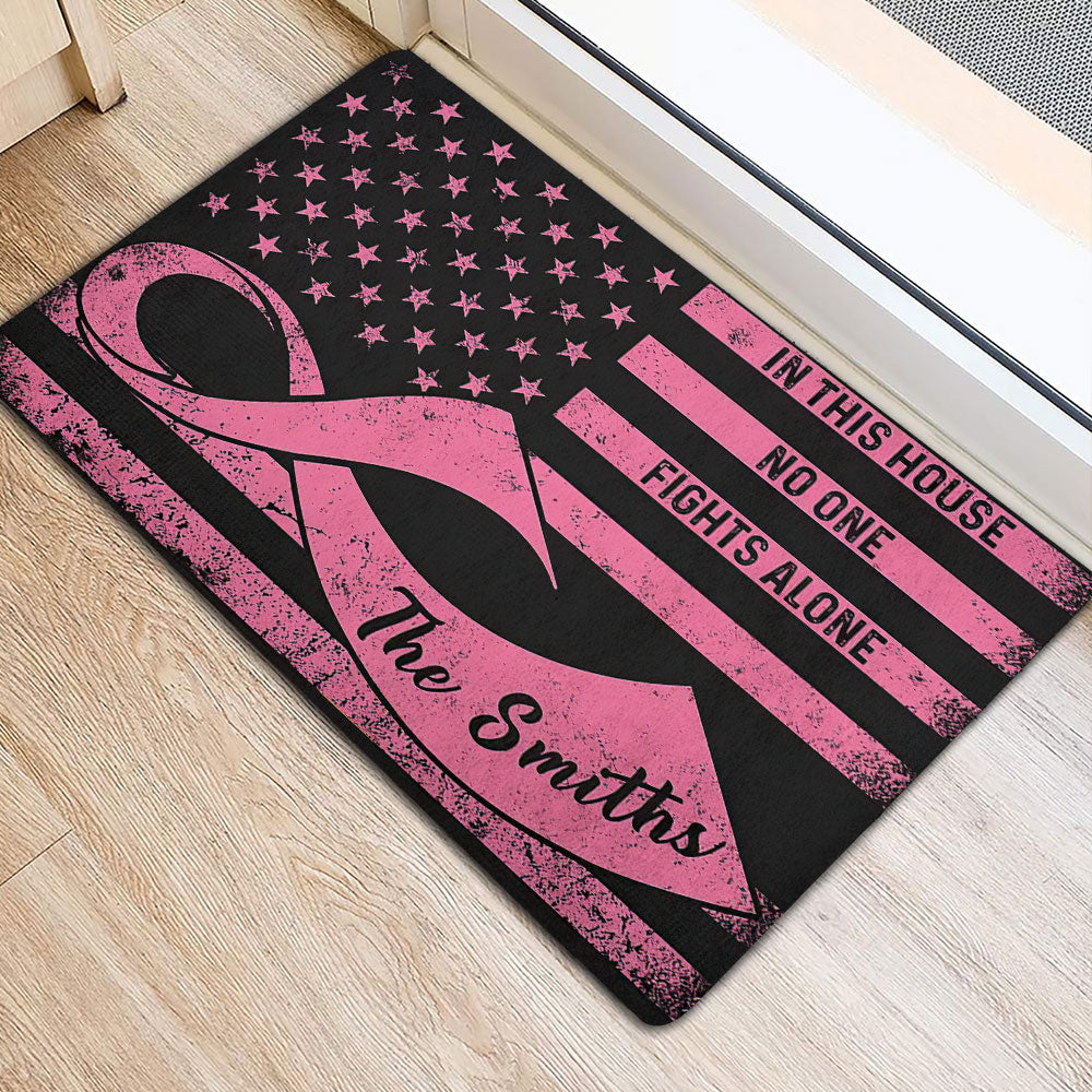 Breast cancer support doormat with pink ribbon artwork shown beside an indoor doorway