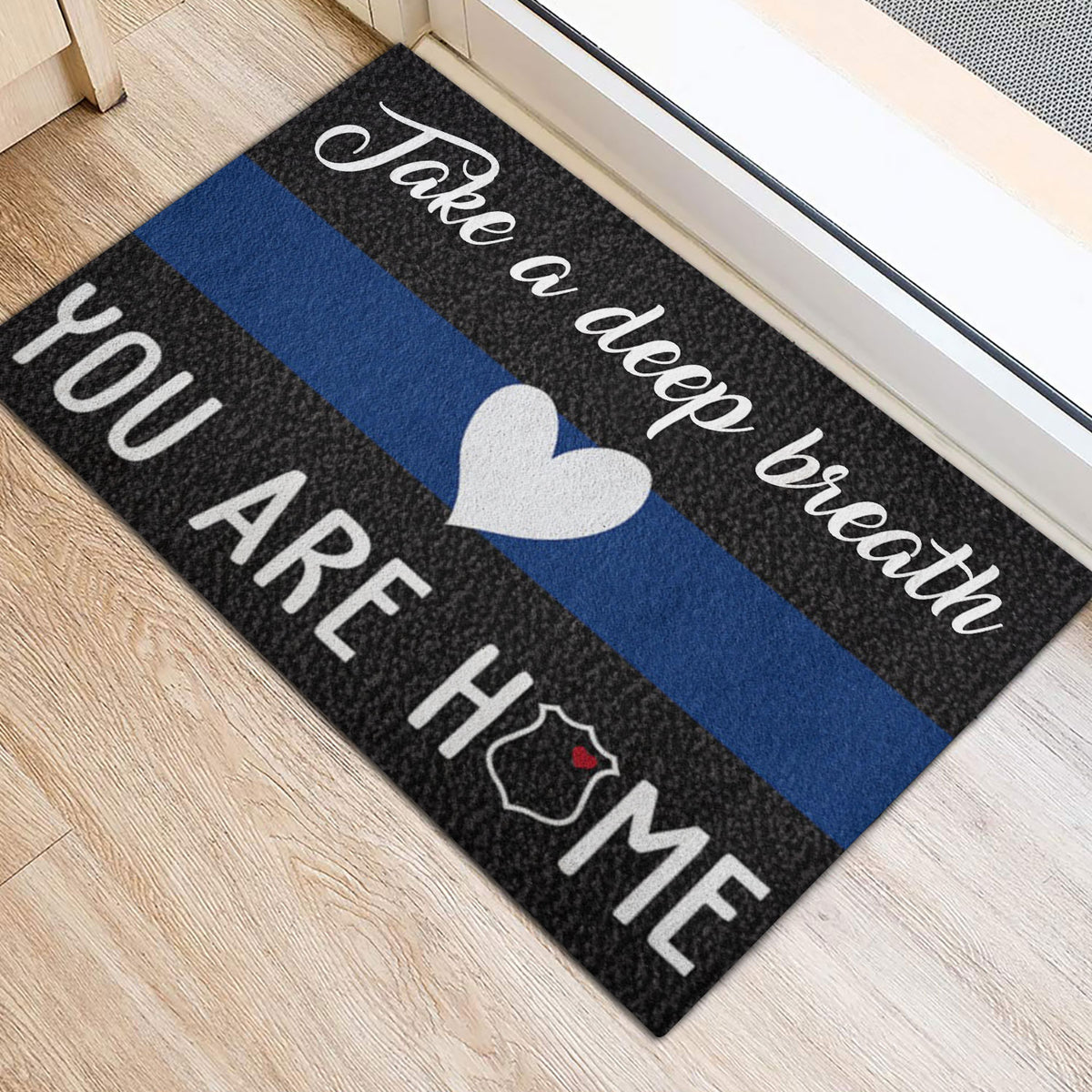 Blue line police doormat positioned beside a doorway with a heart and badge design