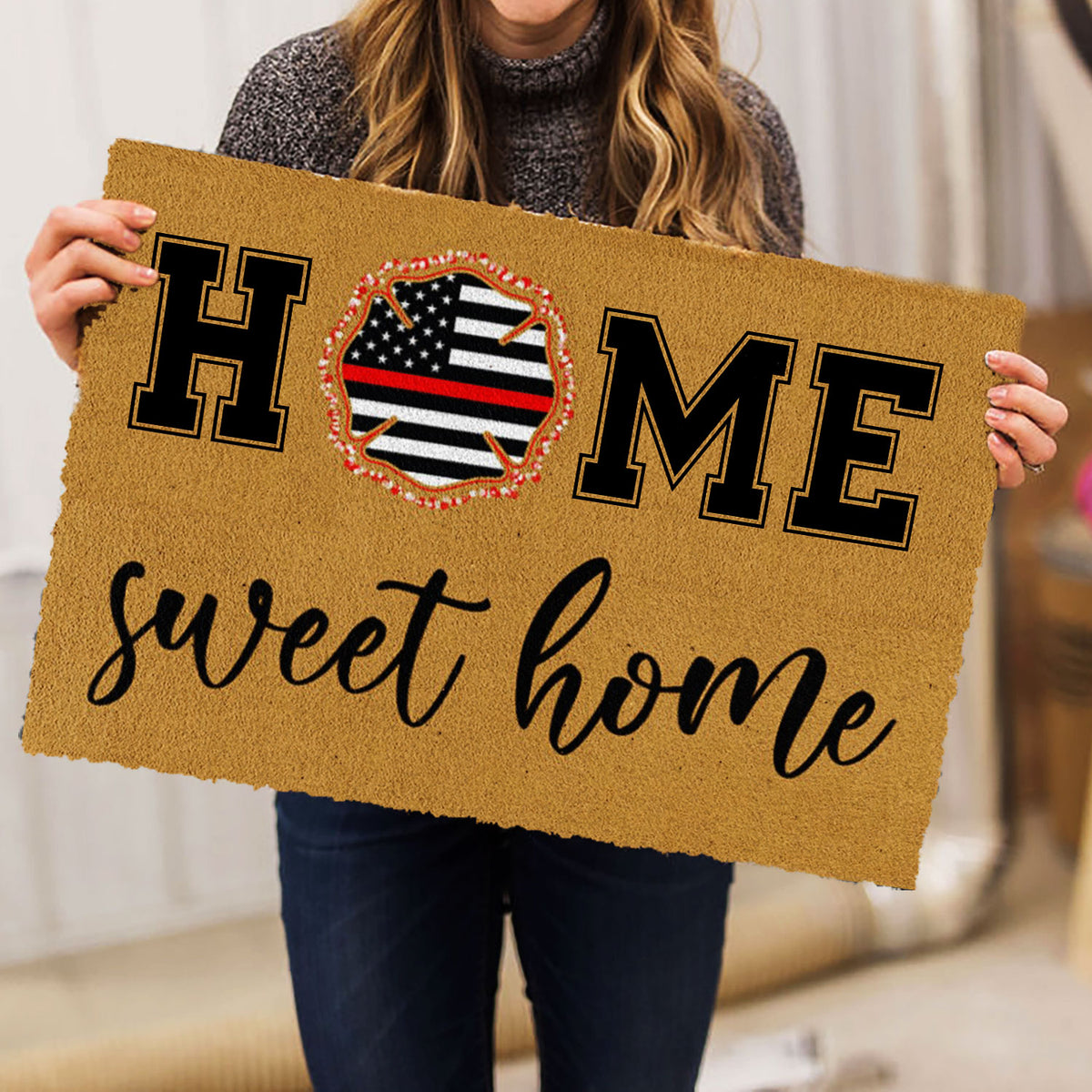 Firefighter doormat held indoors showing the helmet emblem, bold lettering, and welcome message