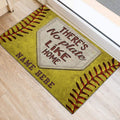 Softball door mat positioned at an entryway, featuring home plate artwork and bold softball seam details