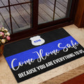 Police entryway mat shown near a glass door with black, white, and blue artwork