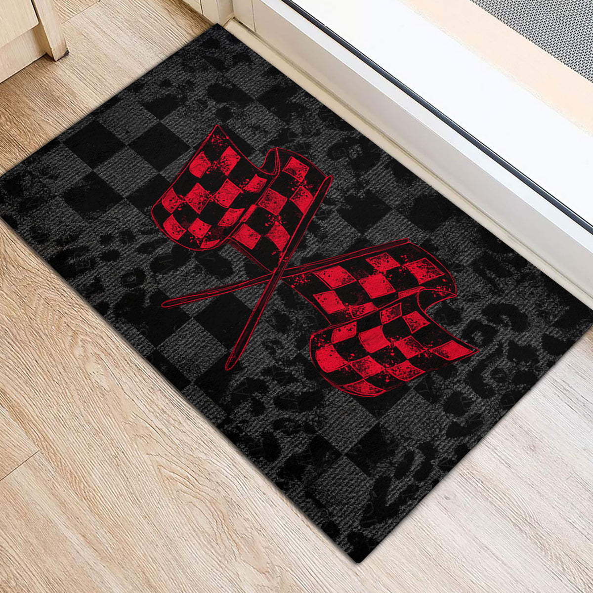 Black racing entryway mat with red crossed flags positioned beside a doorway