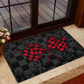 Racing doormat with crossed red flags shown in a home entrance near a glass door
