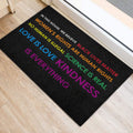 Inclusive LGBT door mat on a light wood floor featuring bold multicolor advocacy text