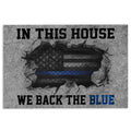 Police-themed doormat with a blue line emblem and bold black lettering on a gray background