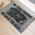 Police support entryway mat shown beside a doorway with gray, black, and blue artwork