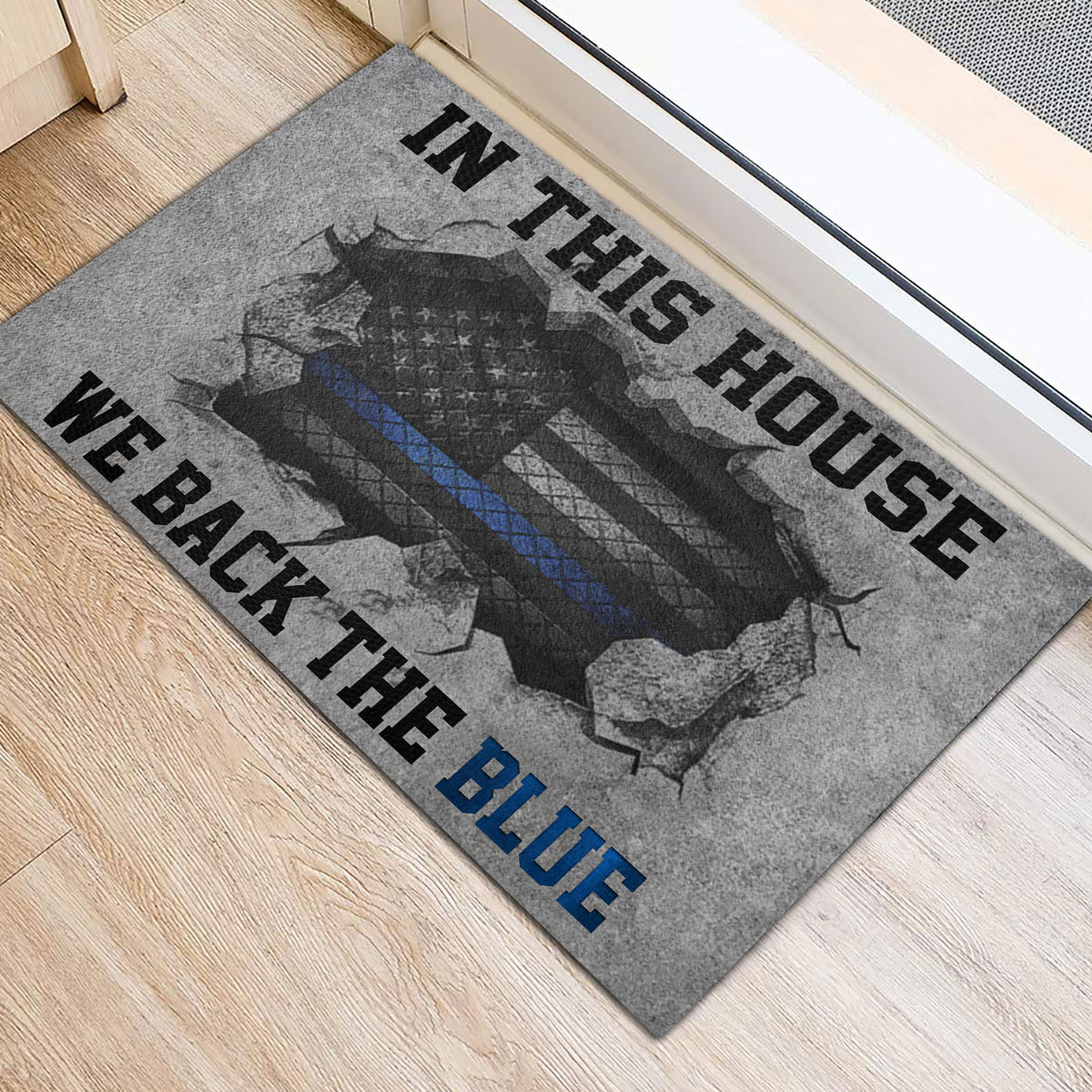 Police support entryway mat shown beside a doorway with gray, black, and blue artwork