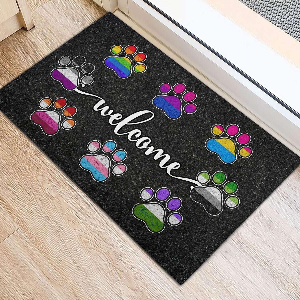 Colorful LGBT paw print door mat arranged around a white welcome message near a doorway