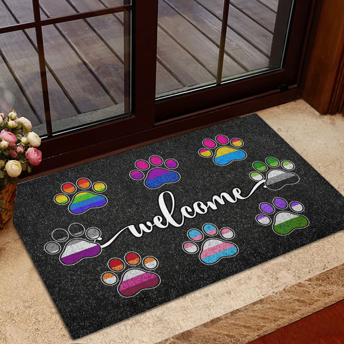 LGBT paw print welcome mat displayed inside a glass doorway near an entrance