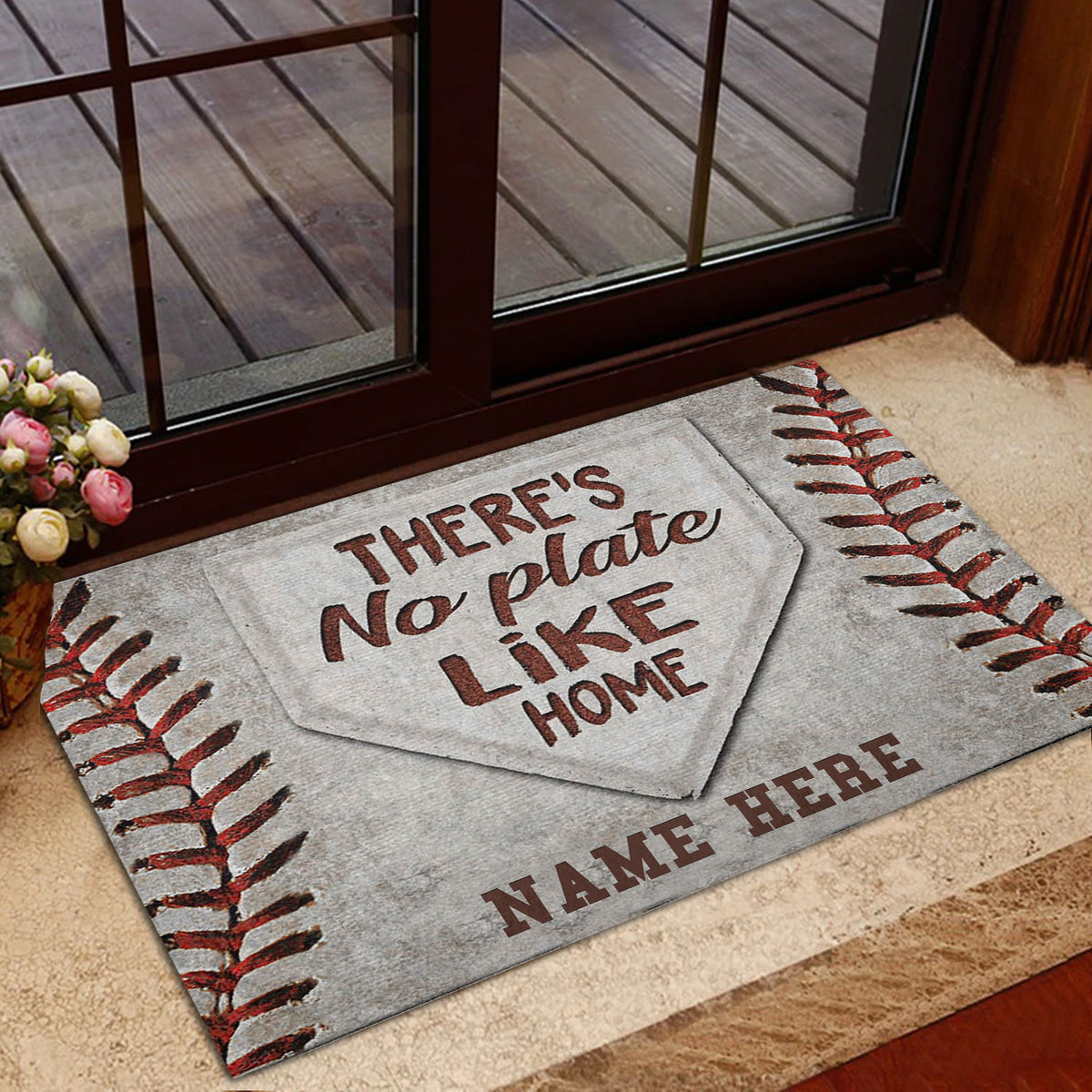 Baseball entryway mat styled near a glass door with red stitching and home plate details