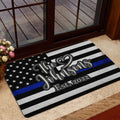 Police-support entryway mat displayed near a glass door with a blue stripe flag design
