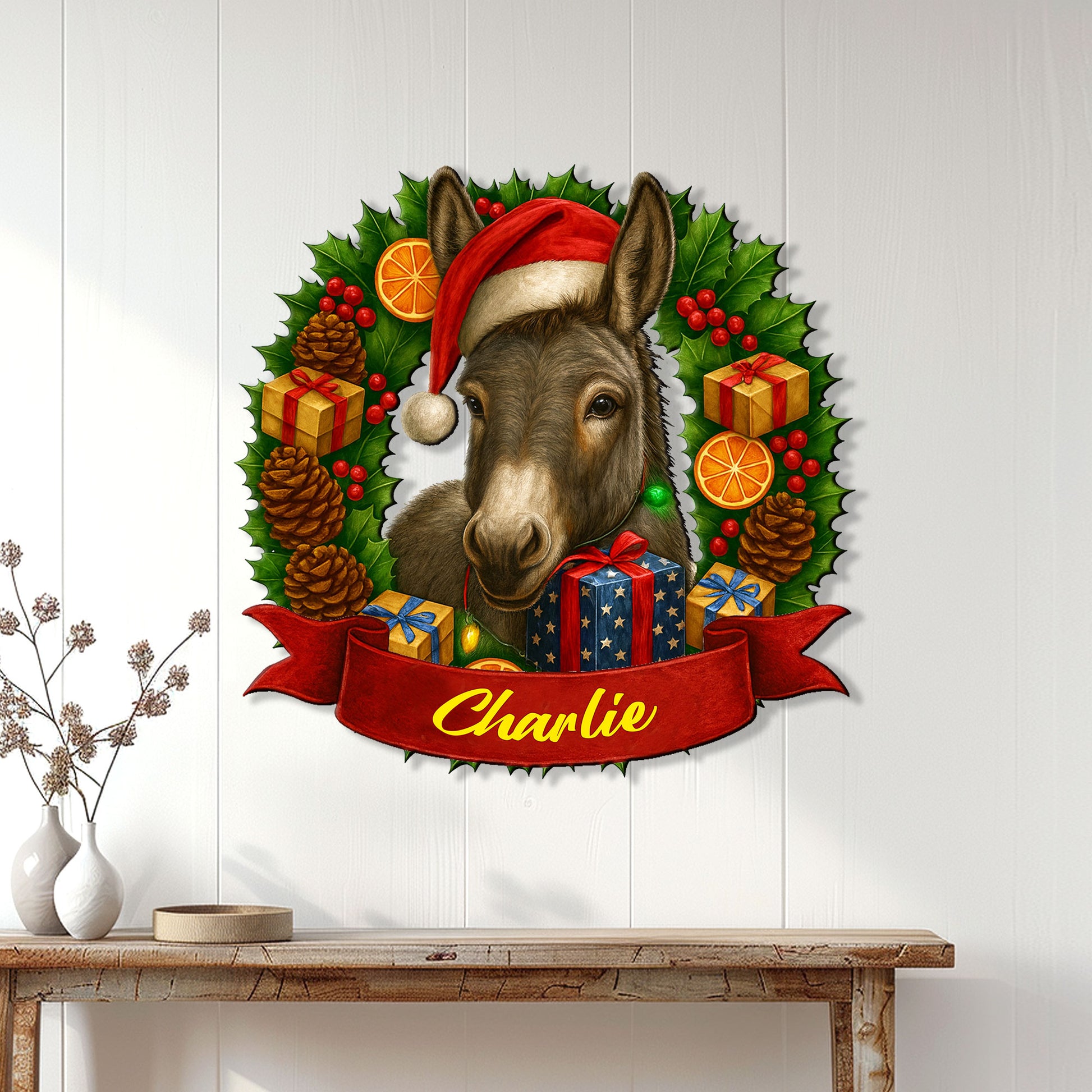 Christmas donkey wall sign displayed on a white paneled wall above a console table