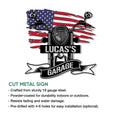 Cut metal biker sign showing a motorcycle grille, high handlebars, patriotic flag backdrop, and garage banner