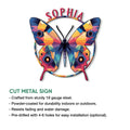 Vibrant butterfly cut metal sign featuring colorful geometric wings and a decorative arched design