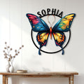 Colorful butterfly wall sign displayed above a console table in a bright, modern home interior