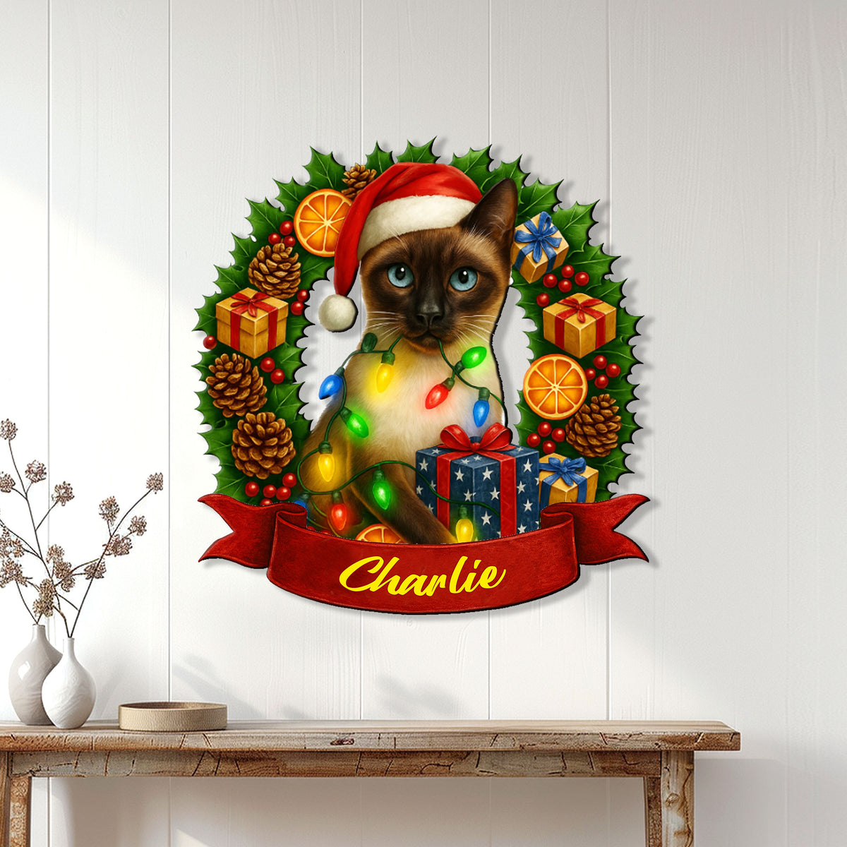 Siamese cat holiday metal sign displayed on a white paneled wall above a console table