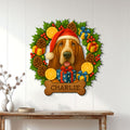 Christmas Basset Hound metal sign displayed on a white paneled wall above a console table