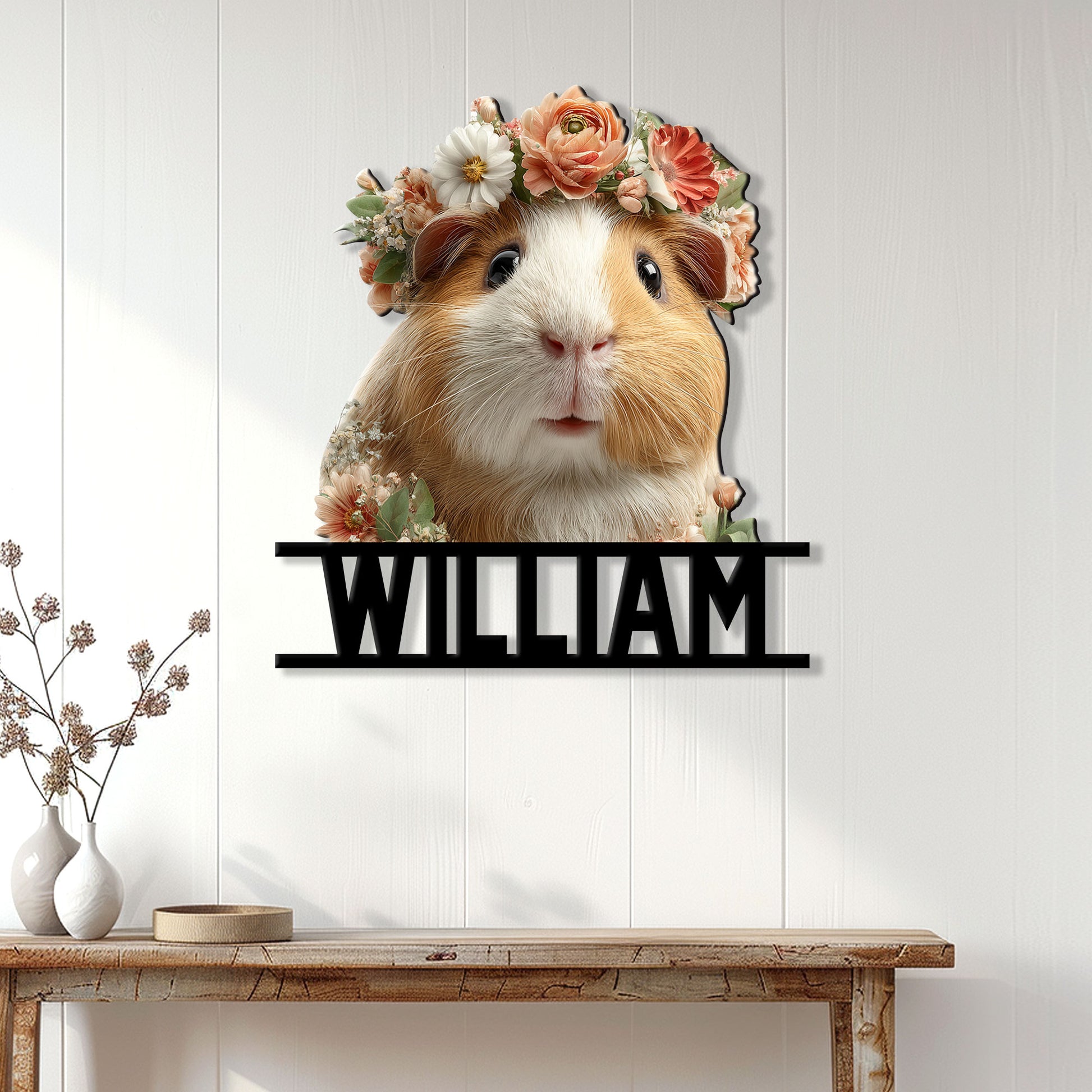 Floral guinea pig wall sign displayed on a light wood-paneled wall above a console table