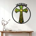Celtic cross metal wall sign displayed on a bright paneled wall above a rustic console table