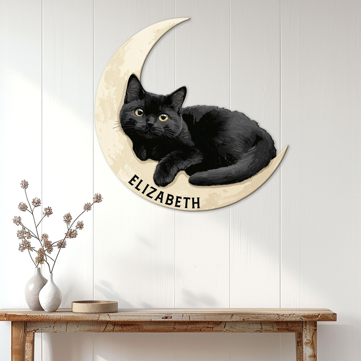 Black cat moon wall decor displayed on a bright paneled wall above a console table