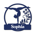 Close-up of a gymnast silhouette metal sign with curved framing and decorative flowers