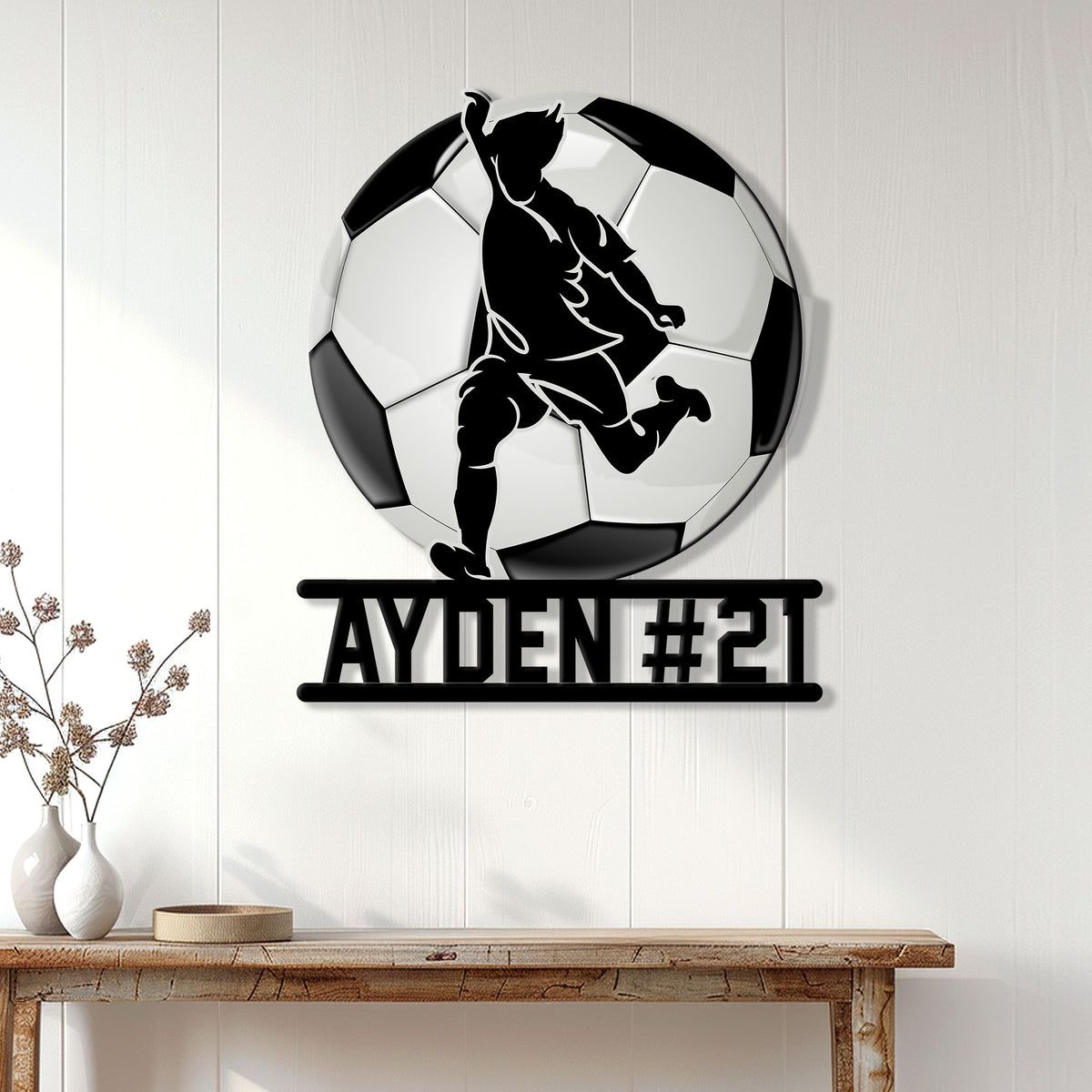 Soccer wall decor displayed on a white paneled wall above a console table