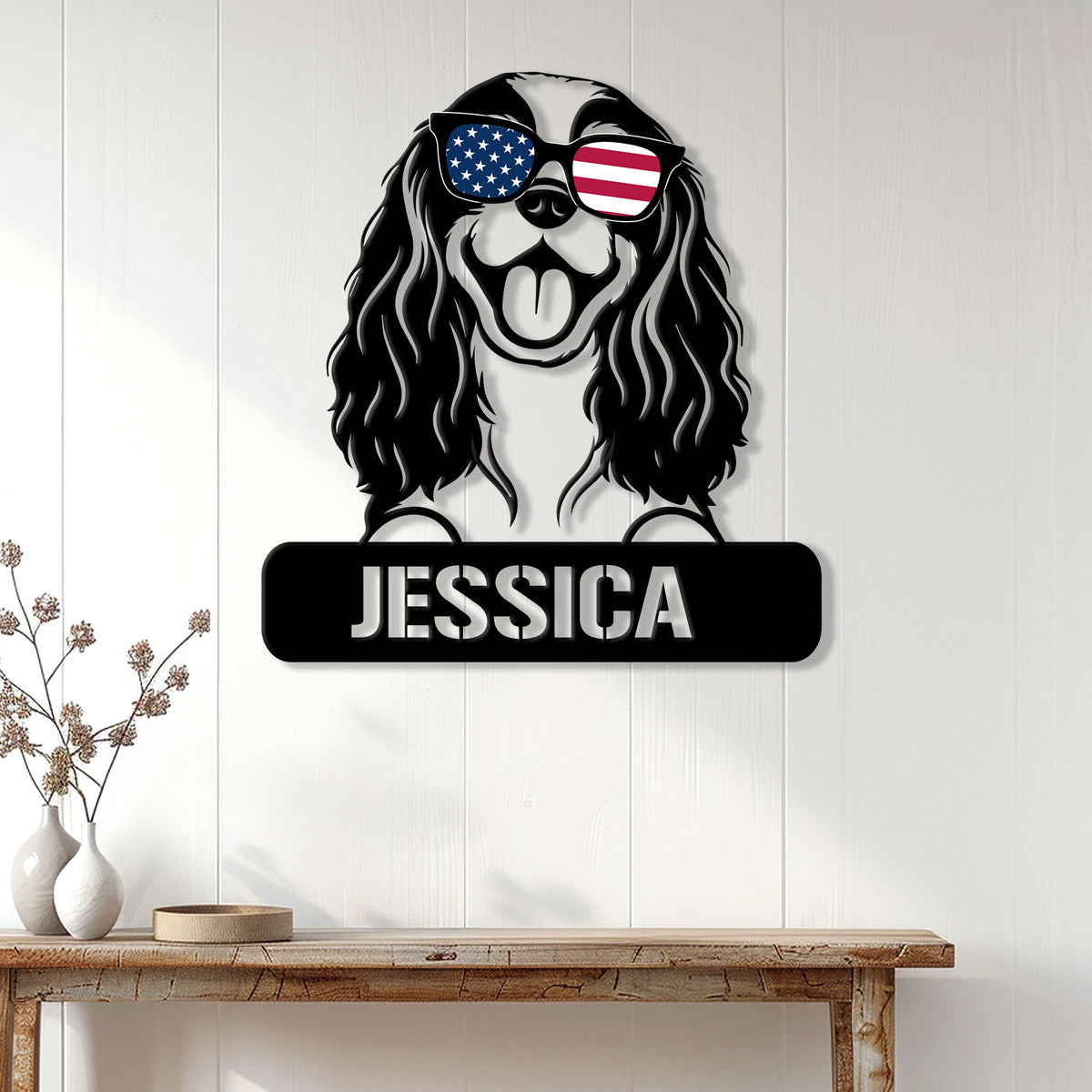 Cavalier King Charles Spaniel wall sign with patriotic sunglasses displayed on a light wood-paneled wall