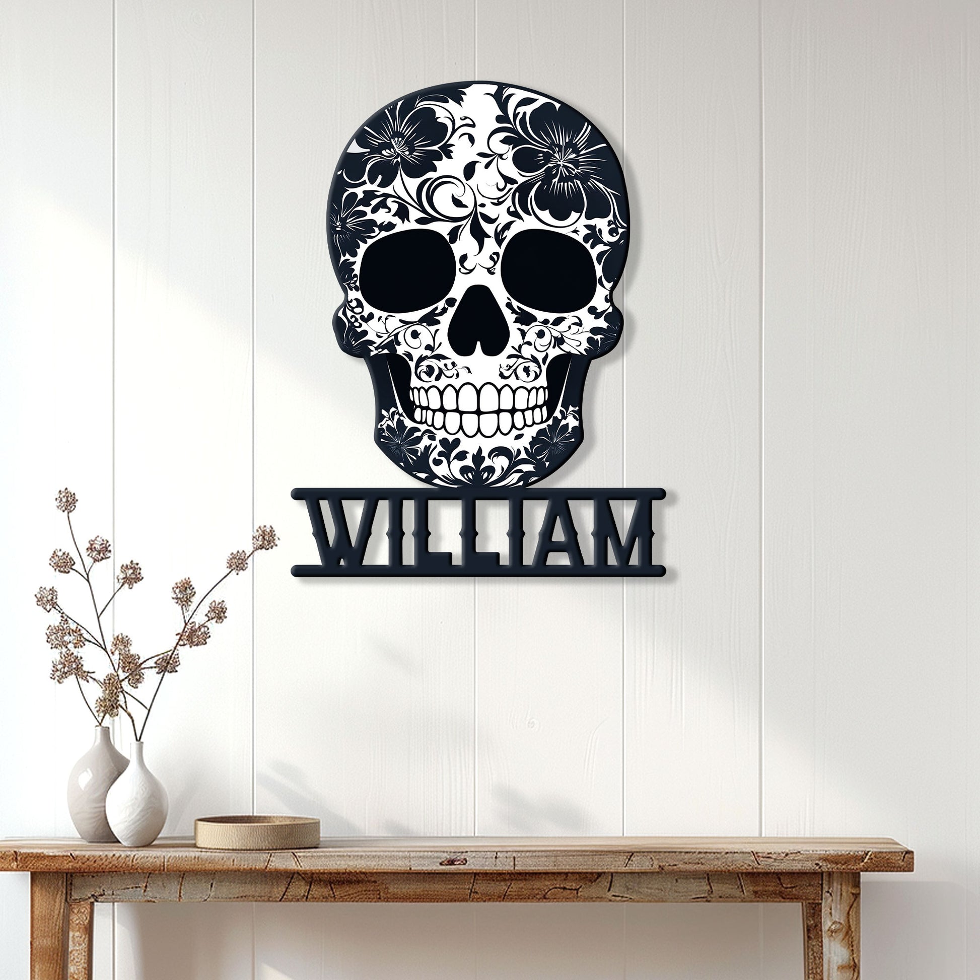 Floral skull metal wall sign displayed on a light paneled wall above a console table
