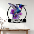 Colorful hummingbird floral metal sign displayed as living room wall decor above a console table