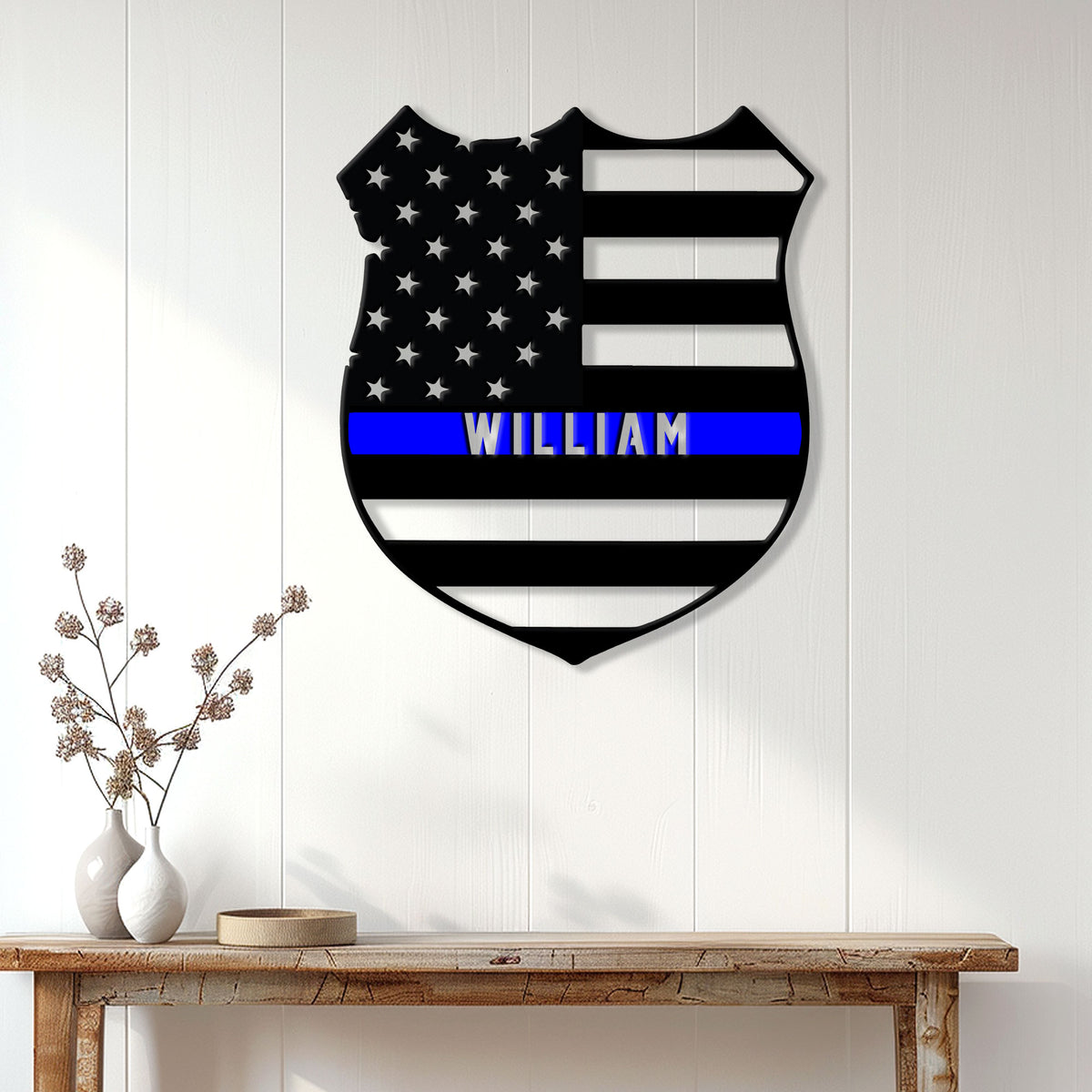 Thin blue line police sign displayed as wall decor above a console table