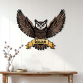 Spread-wing owl metal sign displayed above a console table as bold bird wall decor