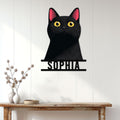 Black cat metal sign displayed as stylish wall decor above a console table in a bright home